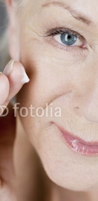 Woman applying wrinkle cream